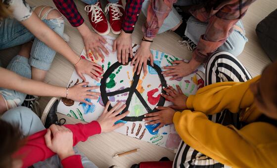 Students paint a peace poster at school.